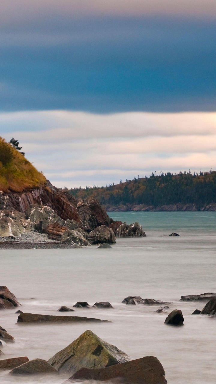 Scenic lighthouse by rocky coastal shore