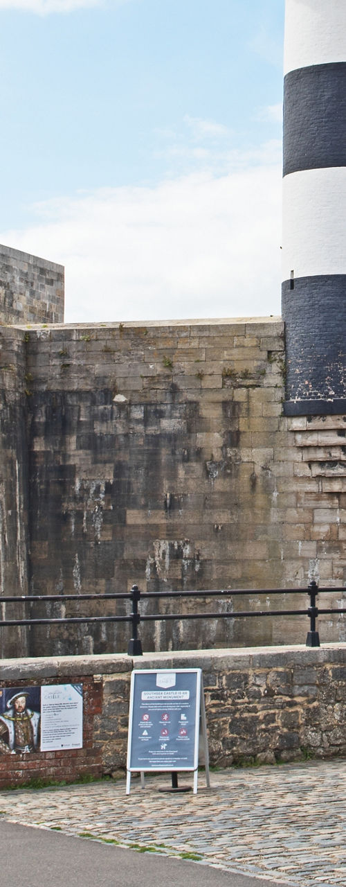 Historic coastal fort with lighthouse and cannon