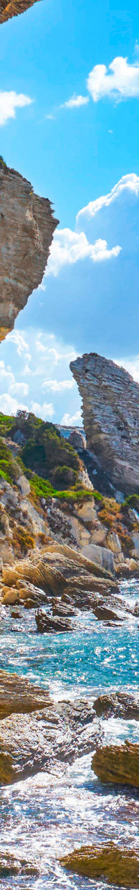 Sunlit coastal cliffs with clear waters