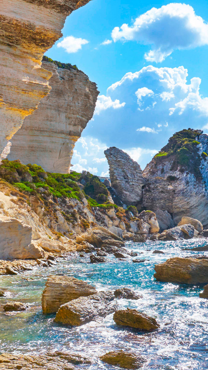 Sunlit coastal cliffs with clear waters