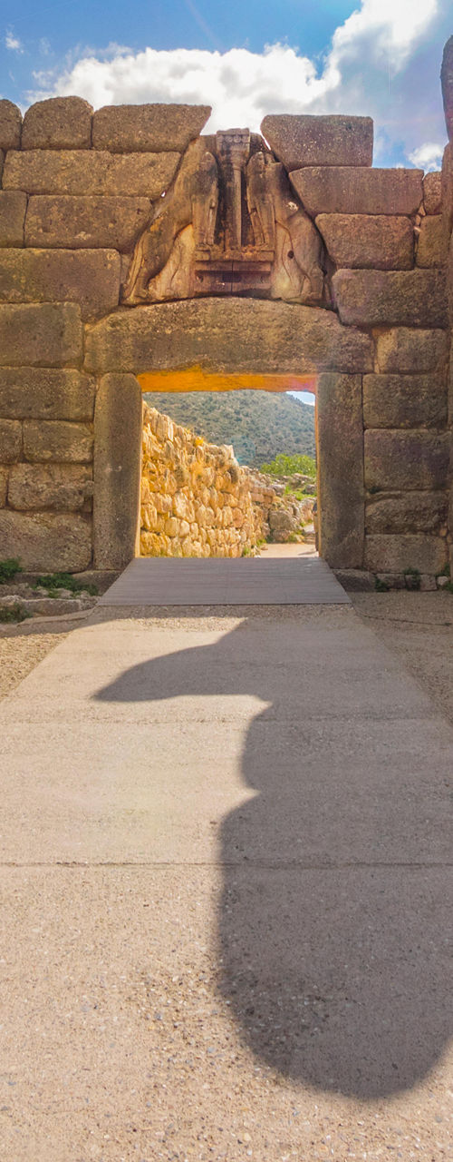 Ancient stone gateway under bright sunlight