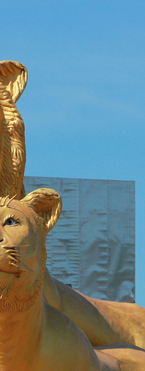 Golden lion statues in outdoor setting