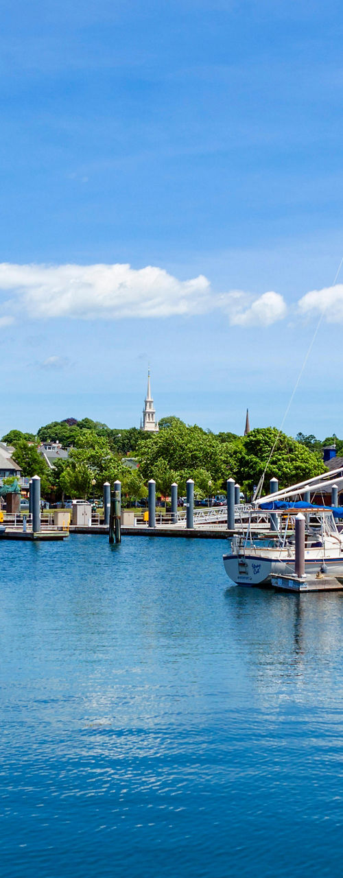 Scenic marina with sailboats under blue sky