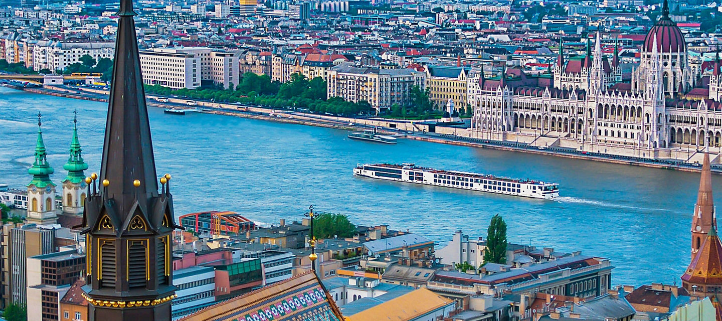 Riverside cityscape with historic cathedral towers