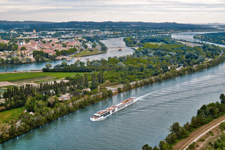 River cruise ship sailing through scenic countryside