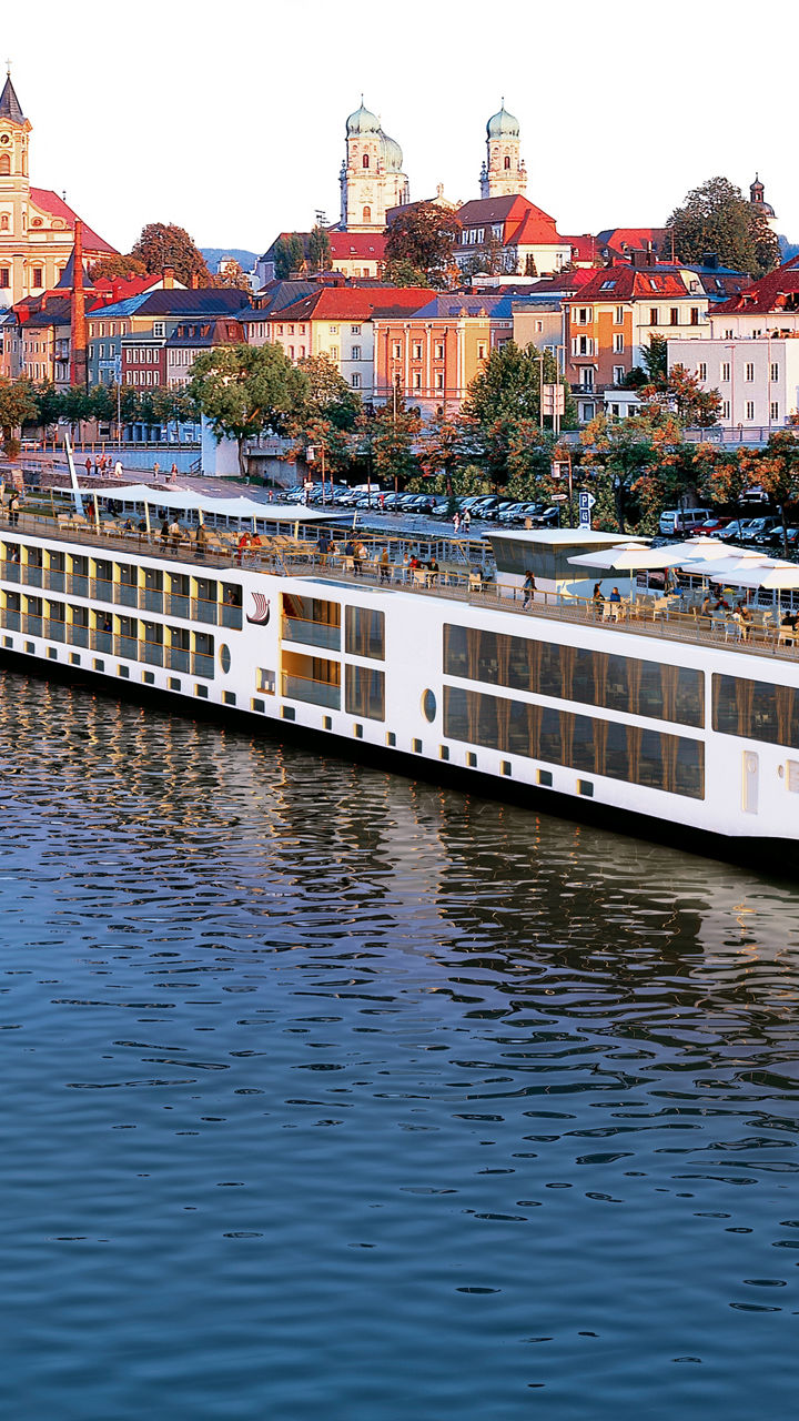 Luxury river cruise ship in scenic town