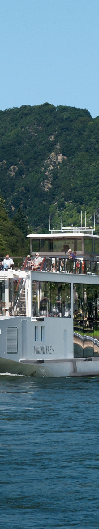 Luxury river cruise ship on scenic waterway
