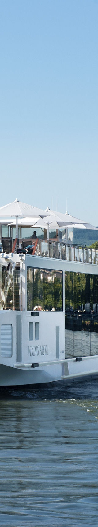 Luxury river cruise ship on scenic waterway