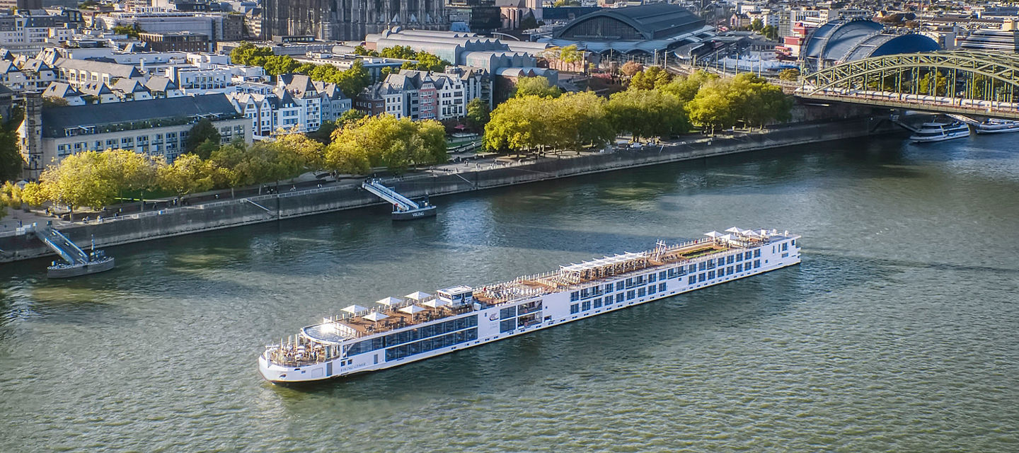River cruise ship passing historic European city