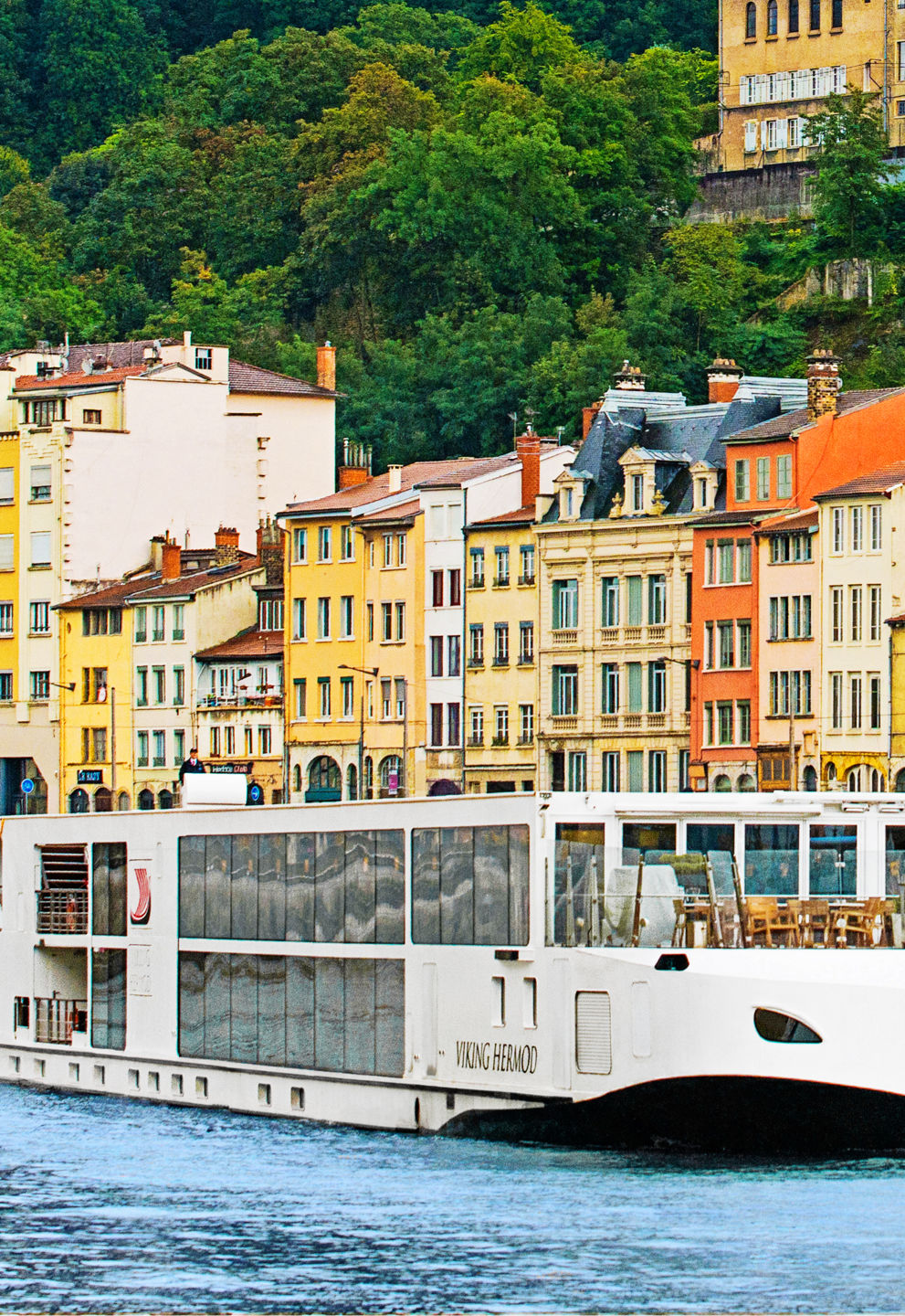 Modern river cruise ship in colorful city