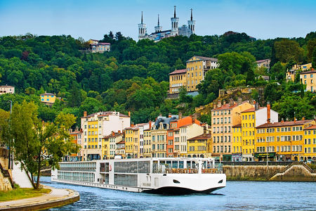 Modern river cruise ship in colorful city