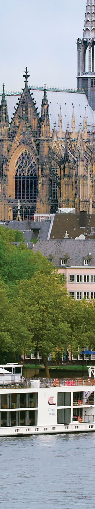 River Cruise Ship Passing Cologne Cathedral Skyline