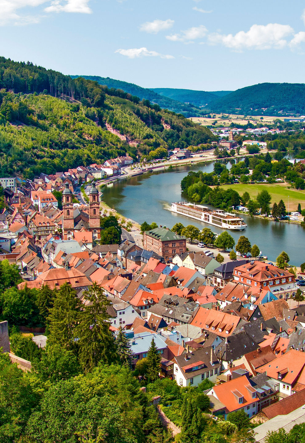 Scenic view of a riverside town and hills