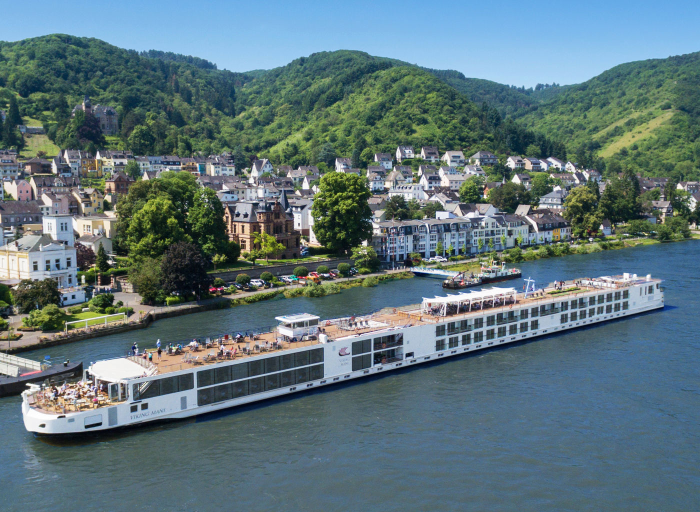 River cruise ship passing scenic European village