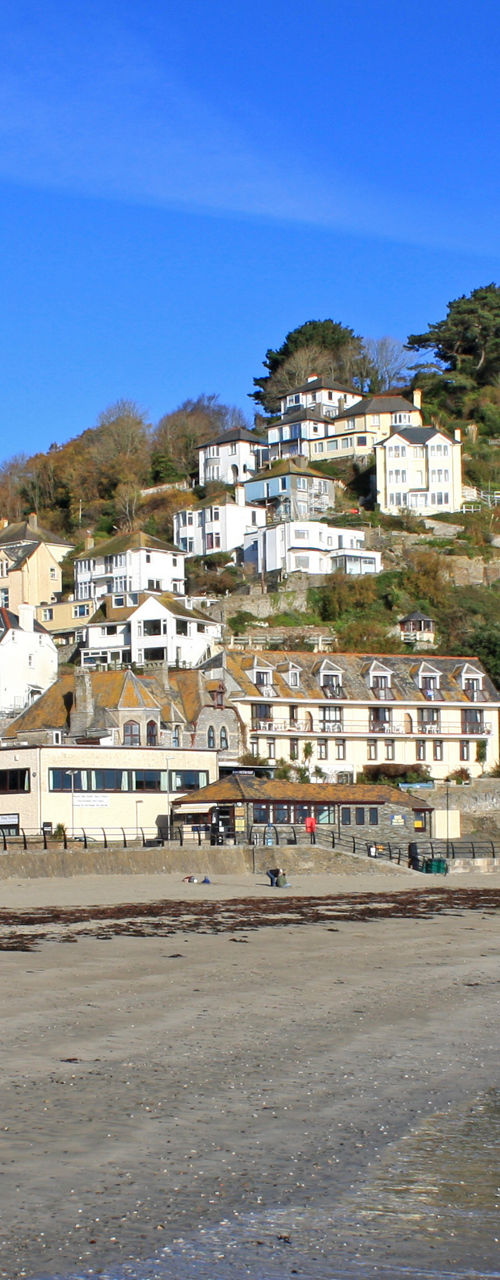 Coastal village and sandy beach on sunny day