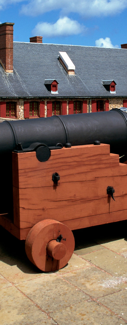 Historic cannon at fortress under blue sky