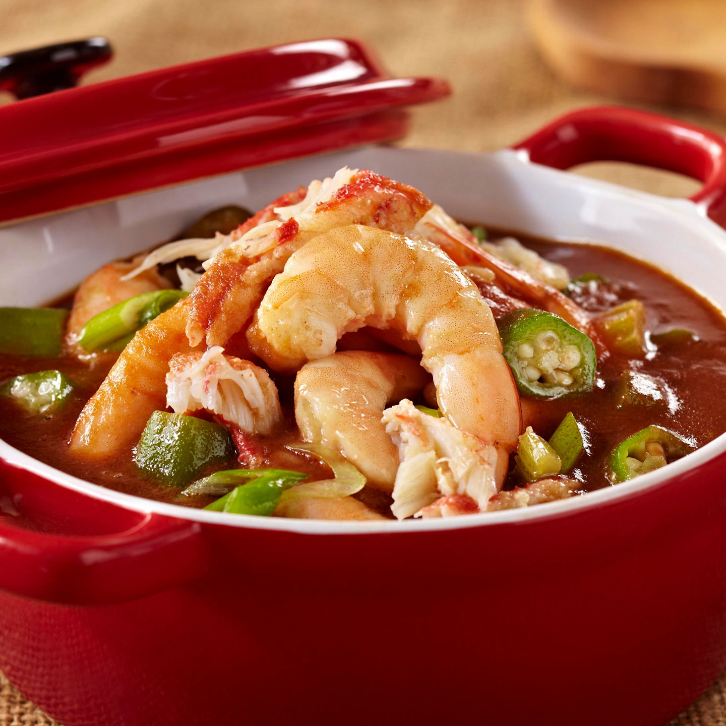 Seafood gumbo in red ceramic pot