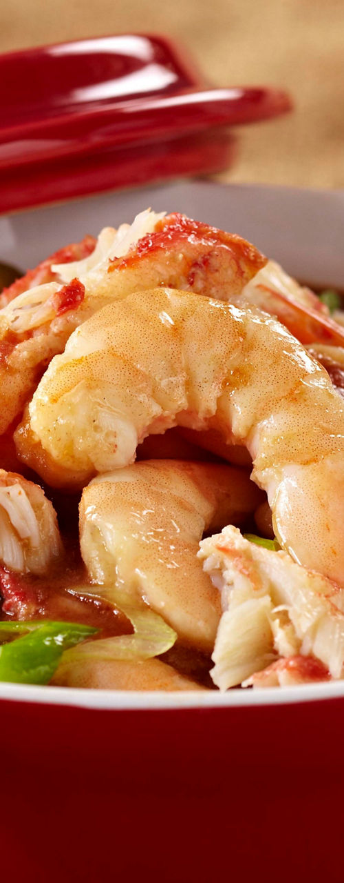 Seafood gumbo in red ceramic pot