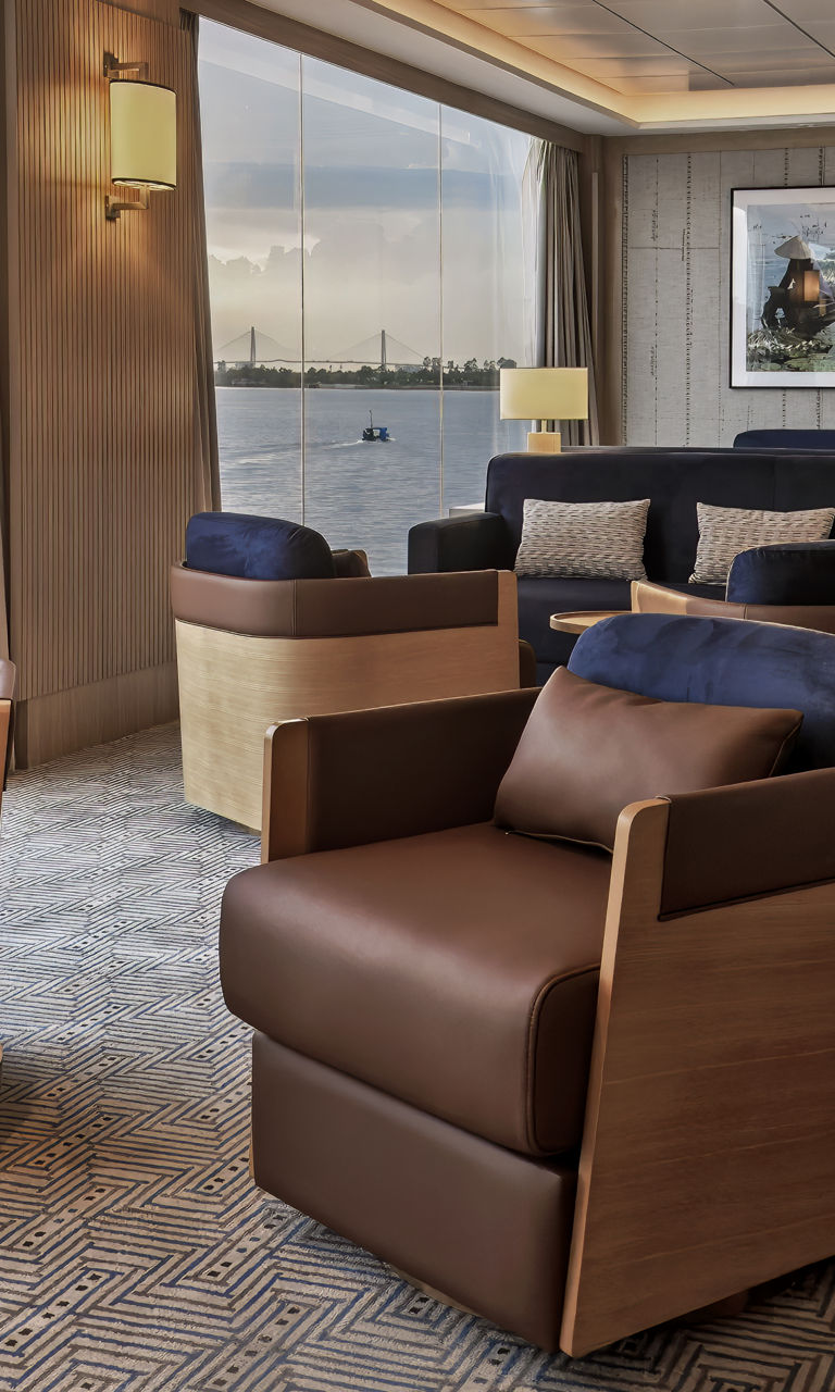 Modern lounge with panoramic waterfront sunset view