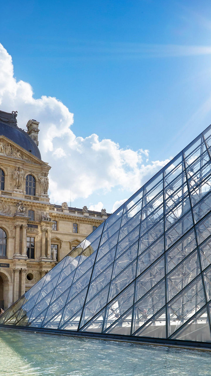 Louvre Museum and glass pyramid in sunlight