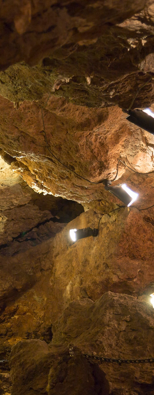 Illuminated rocky cave interior with pathway