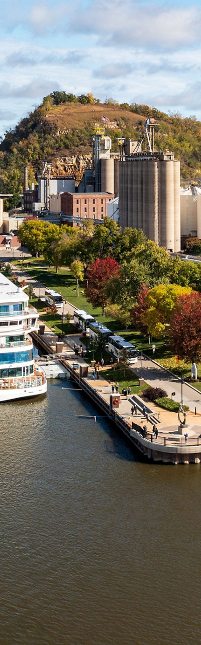 Scenic riverside town with docked cruise ship