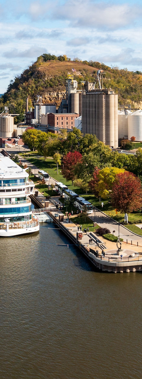 Scenic riverside town with docked cruise ship