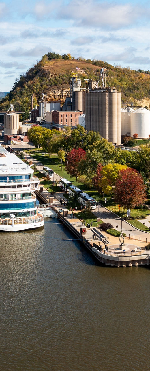Scenic riverside town with docked cruise ship