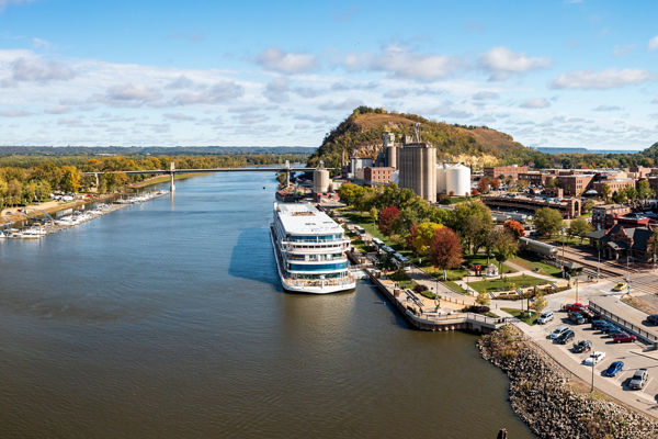 Scenic riverside town with docked cruise ship