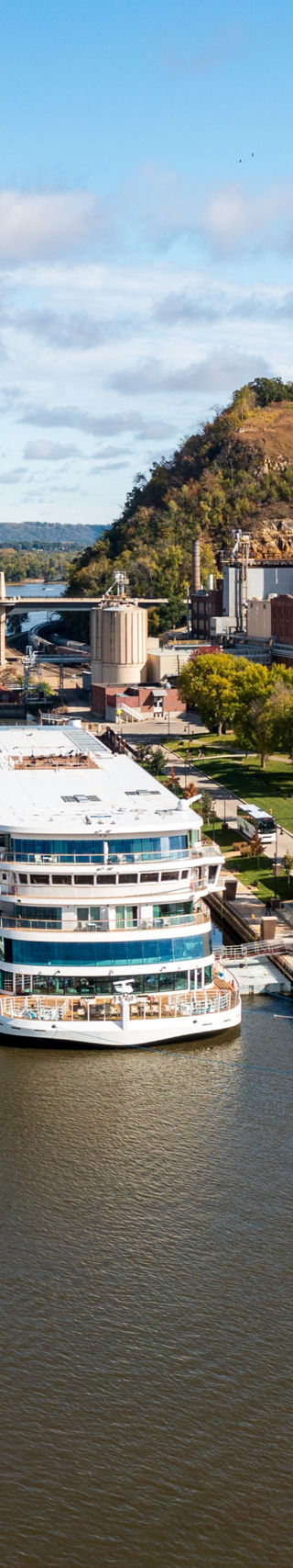 Scenic riverside town with docked cruise ship