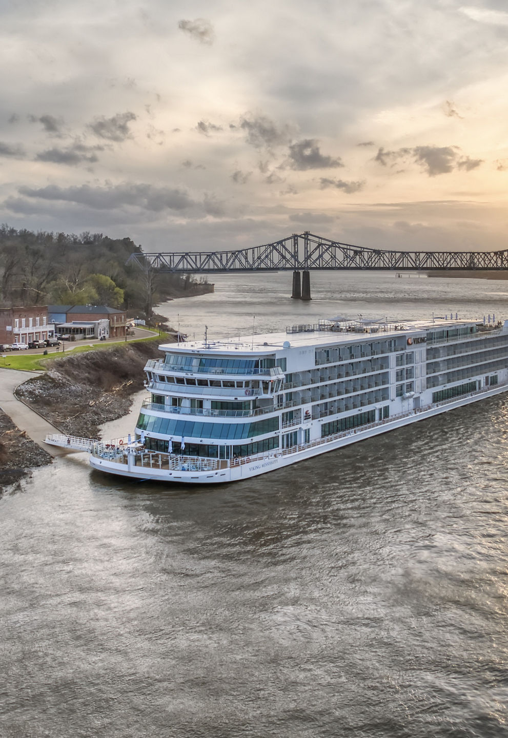 River cruise ship near sunset bridge