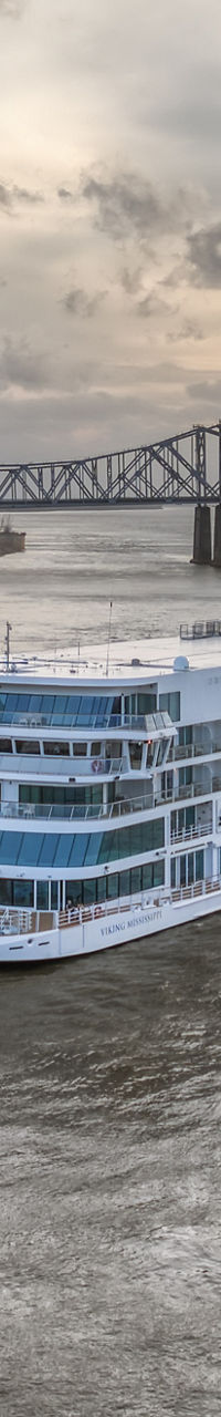 River cruise ship near sunset bridge