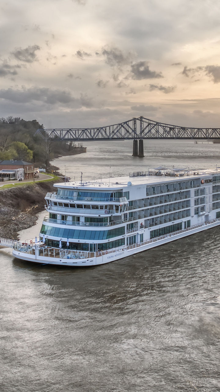 River cruise ship near sunset bridge