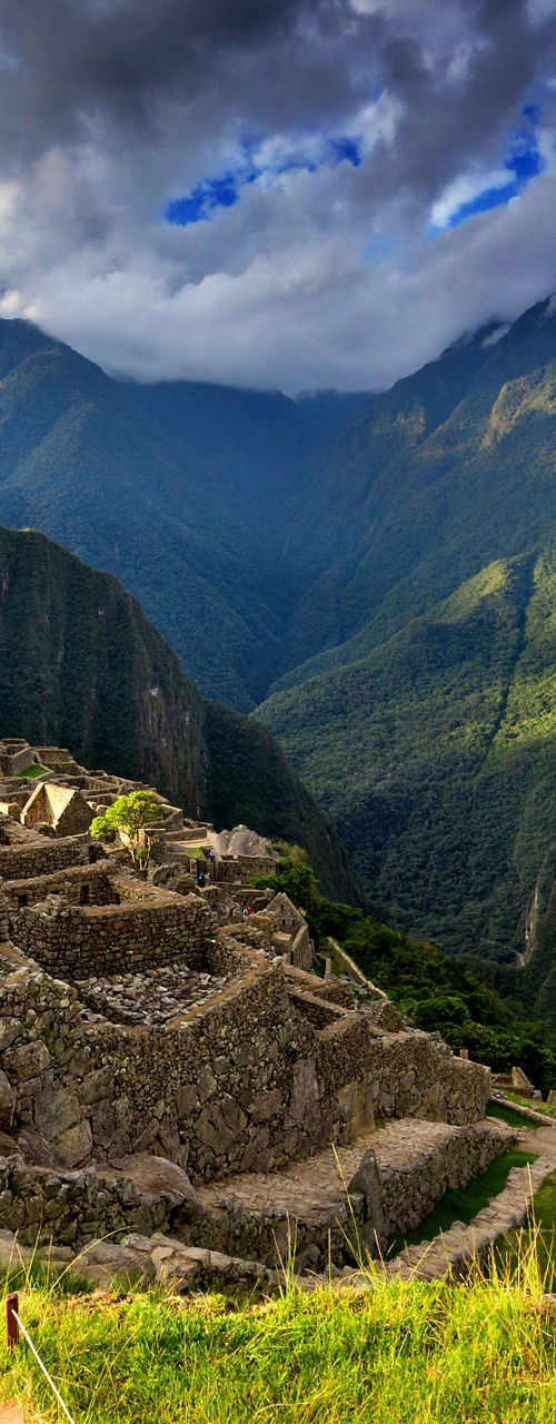 Traveler exploring ancient Machu Picchu ruins