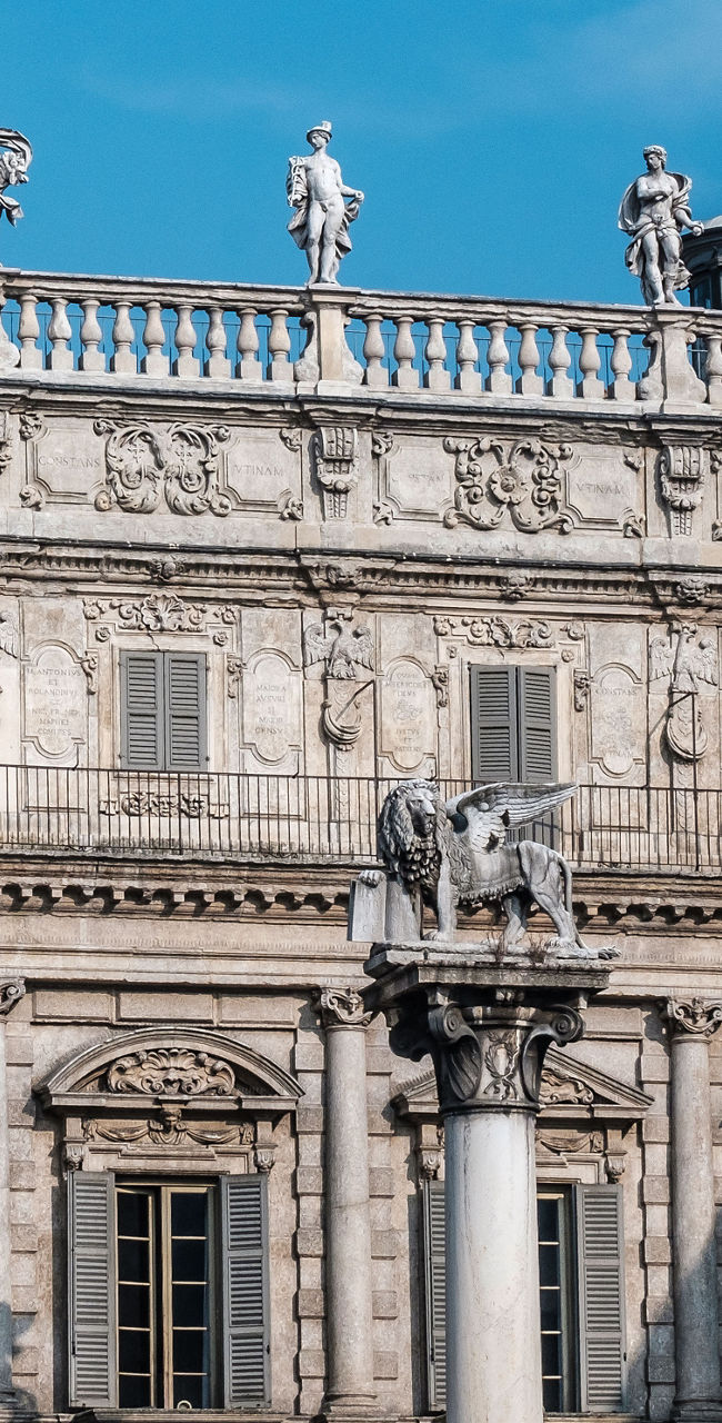 Historic building with statues in urban square