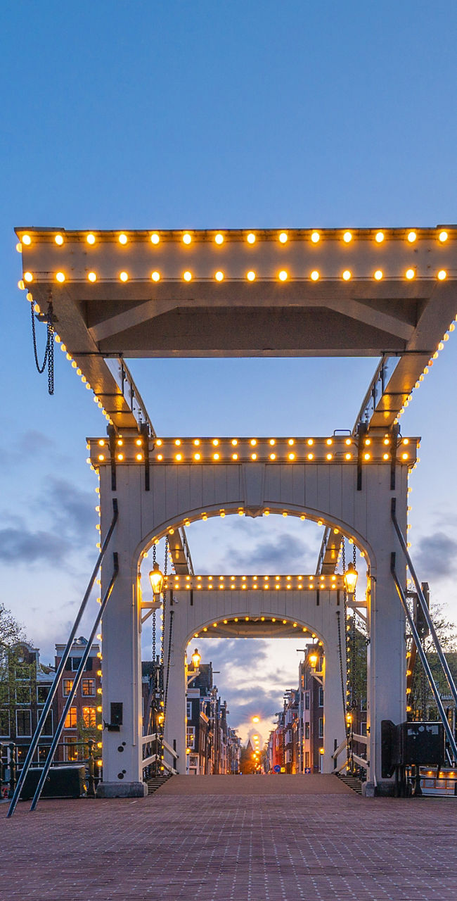 Illuminated bridge at sunset in Amsterdam