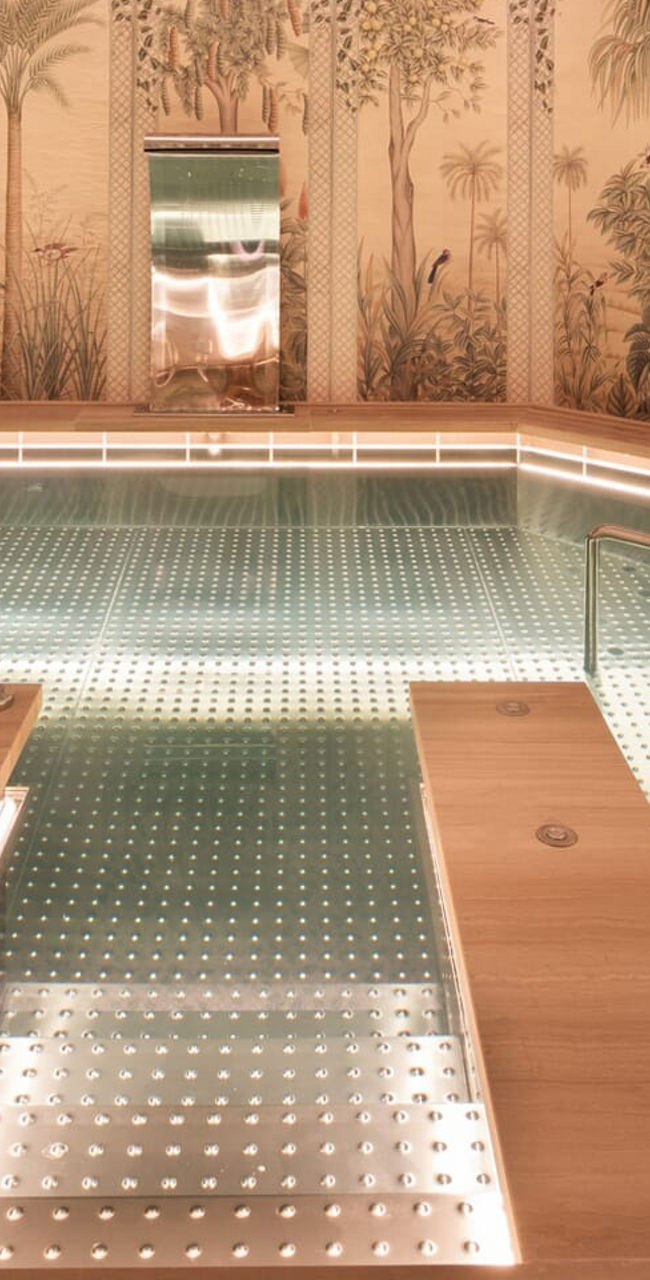 Luxurious indoor pool with tropical decor