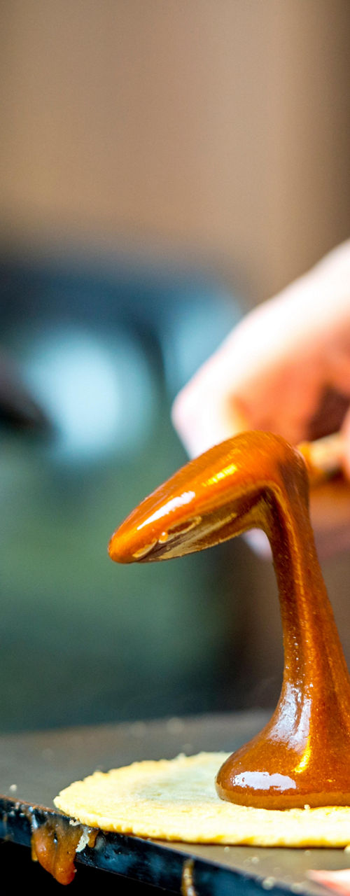 Caramel being poured onto waffle