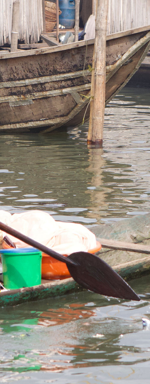 Mother and child in wooden canoe on water