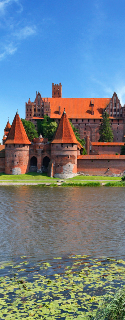 Historic castle by serene riverside view