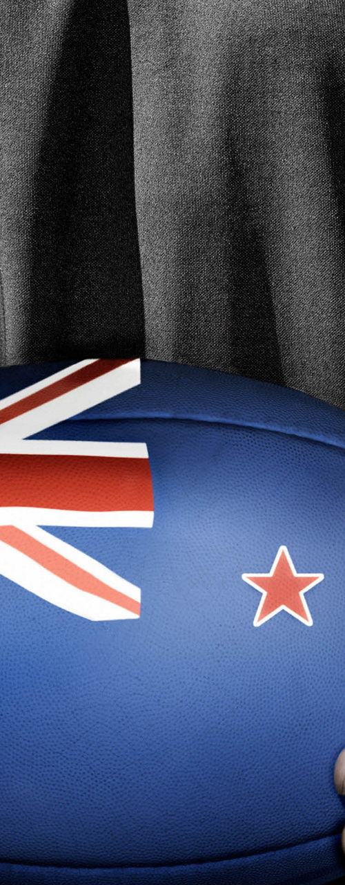 Rugby player holding New Zealand ball