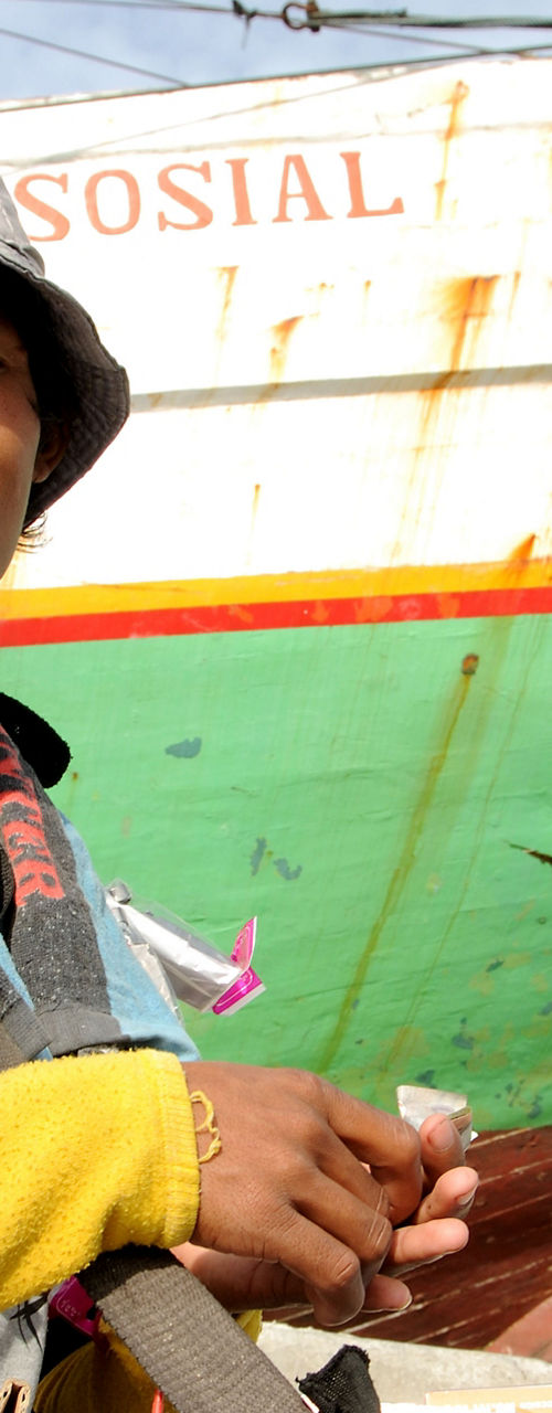 Street vendor near colorful docked boat
