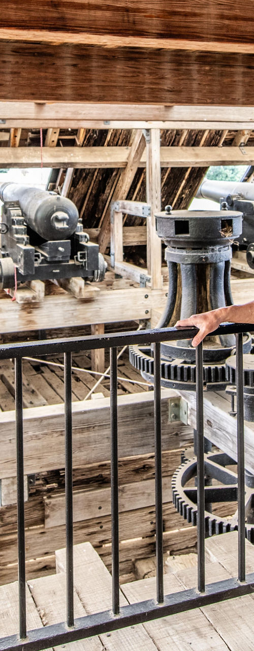Man observing large wooden industrial machinery