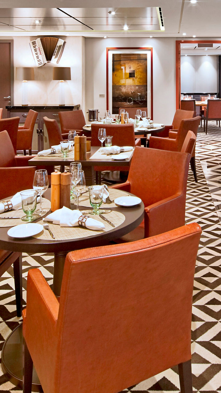 Modern restaurant dining room with orange chairs