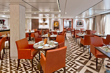Modern restaurant dining room with orange chairs