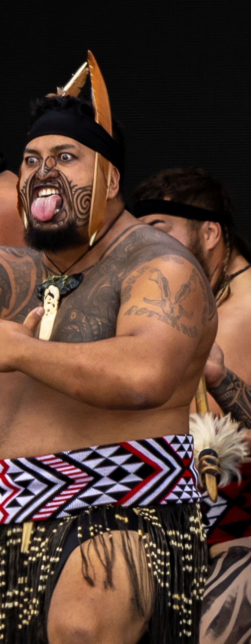 Traditional tattooed dancers performing cultural ceremony