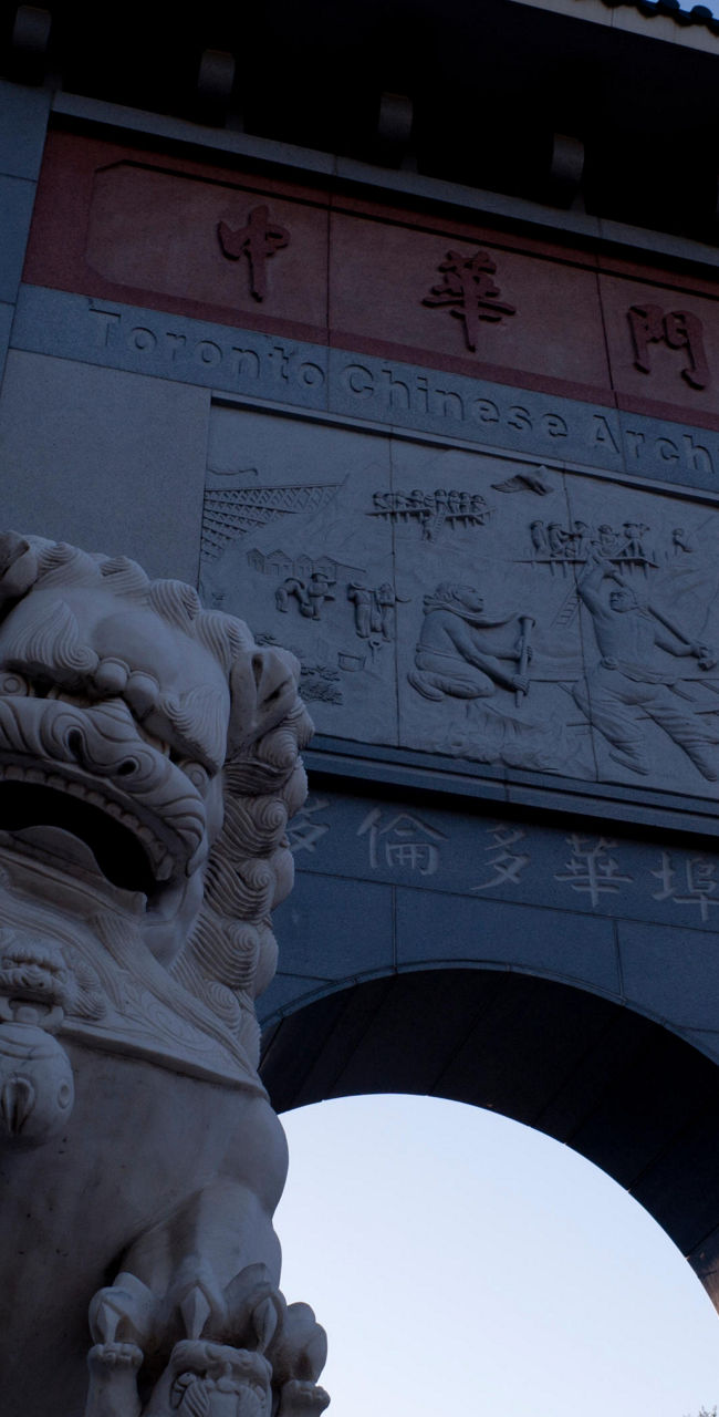 Stone lion statue at Chinese archway