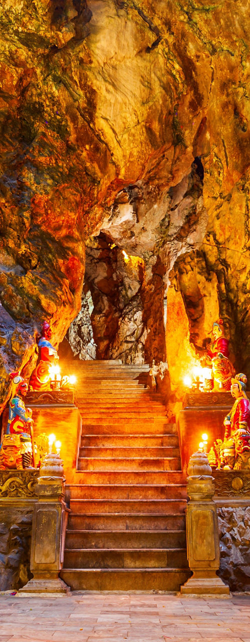 Illuminated cave temple with vibrant rock formations