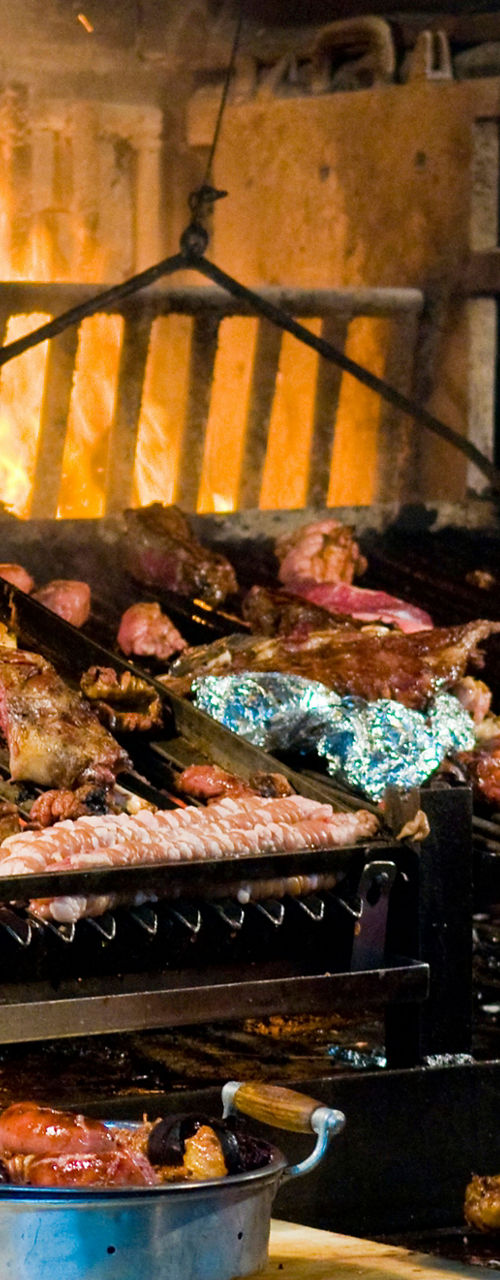 Chef grilling assorted meats and vegetables