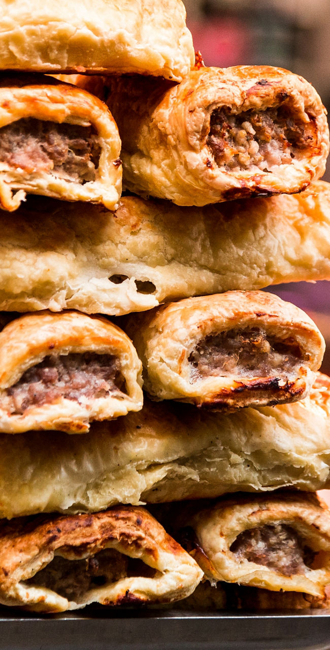Stacked meat pastries at street food stall